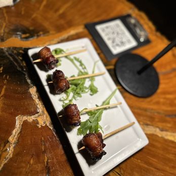 Milk & Honey signature dishes Bacon Wrapped DatesPB & J SlidersPatatas Bravas